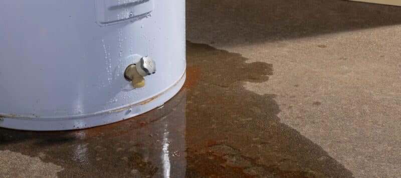 water heater that is leaking water creating a puddle