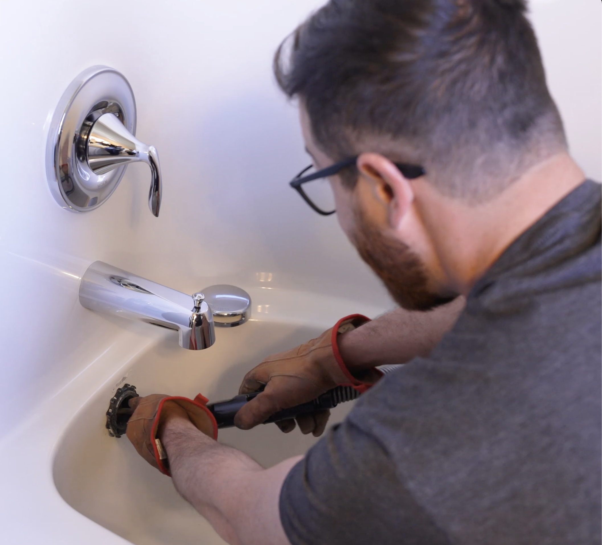 Raptor Rooter & Plumbing technician repairing a faucet in a Spokane Valley home