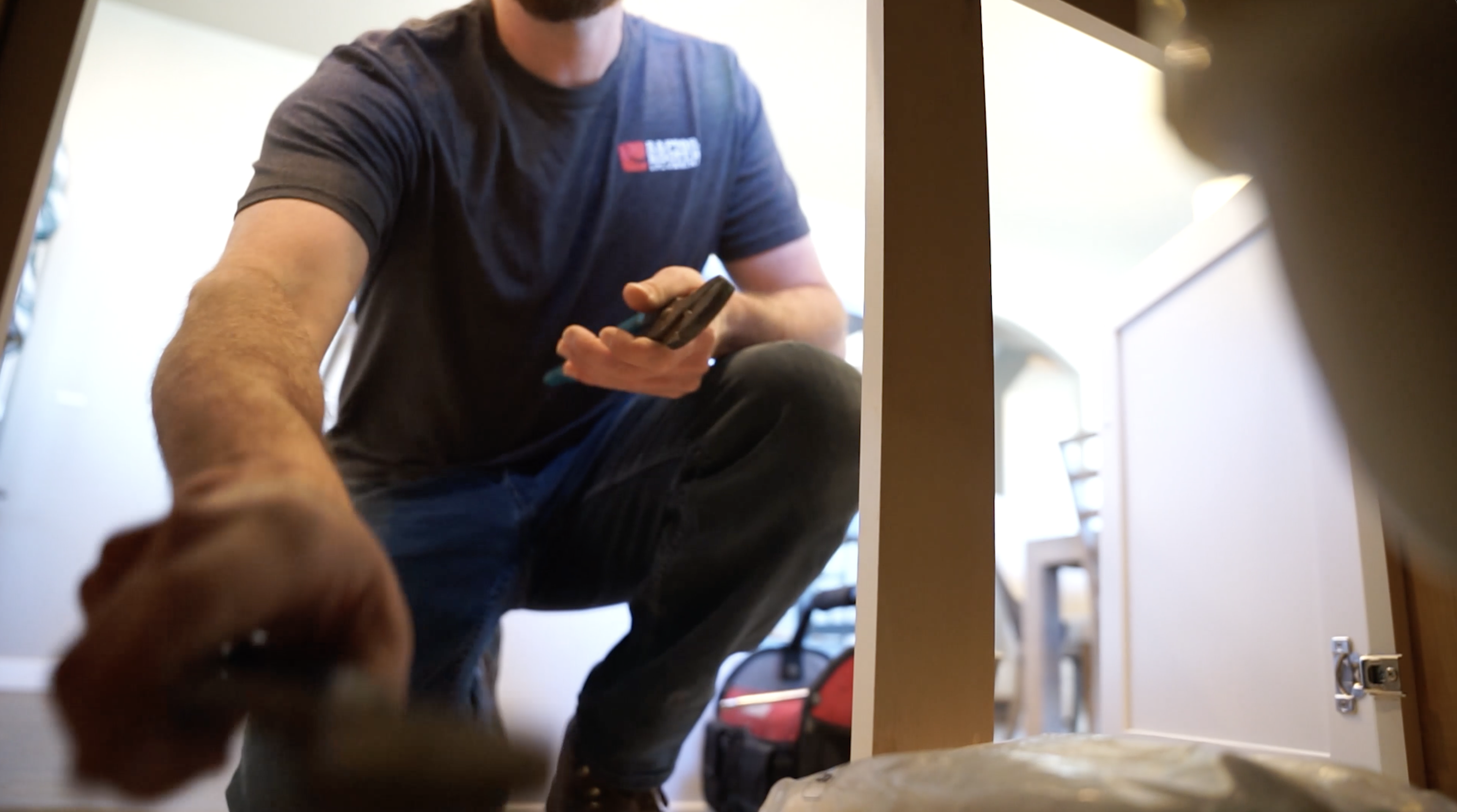 Raptor Rooter & Plumbing plumber fitting a water treatment system in a Spokane Valley home